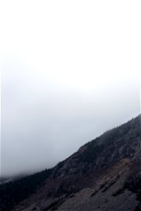 Mountainside Against Thick Fog photo