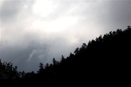 Hill Silhouette Against Cloudy Sky photo