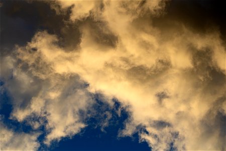 Sepia-Tone Clouds Against Blue Sky photo