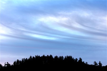 Swirling Clouds Over Hill photo