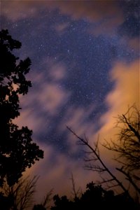 Blurry Clouds Moving Across Night Sky photo
