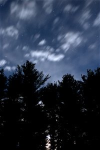 Moving Small Clouds Across Night Sky photo