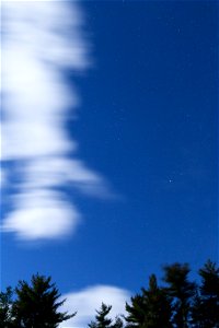 Brilliant Blue Sky with White Clouds Moving Through photo