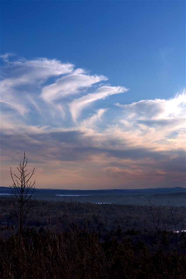 Curling Clouds Over Dim Landscape