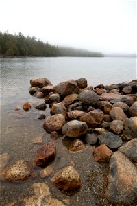 Pile of Rocks in Foggy Lake photo