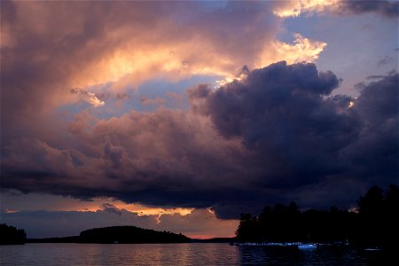 Stormy Sunset Clouds Over Water photo