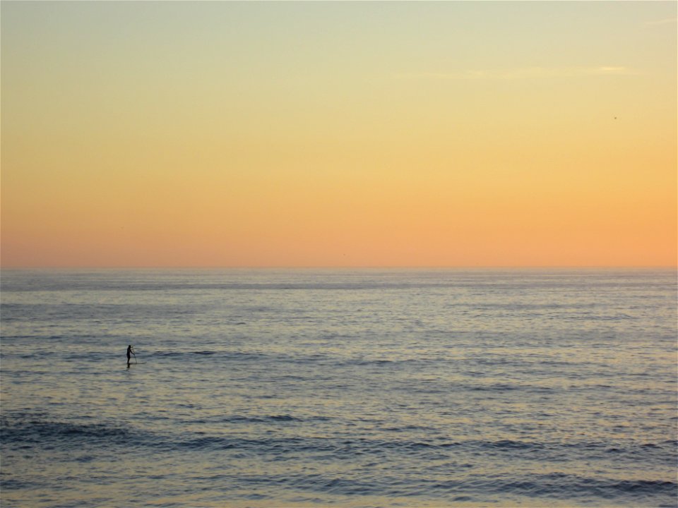 Person on the Ocean at Sunset photo