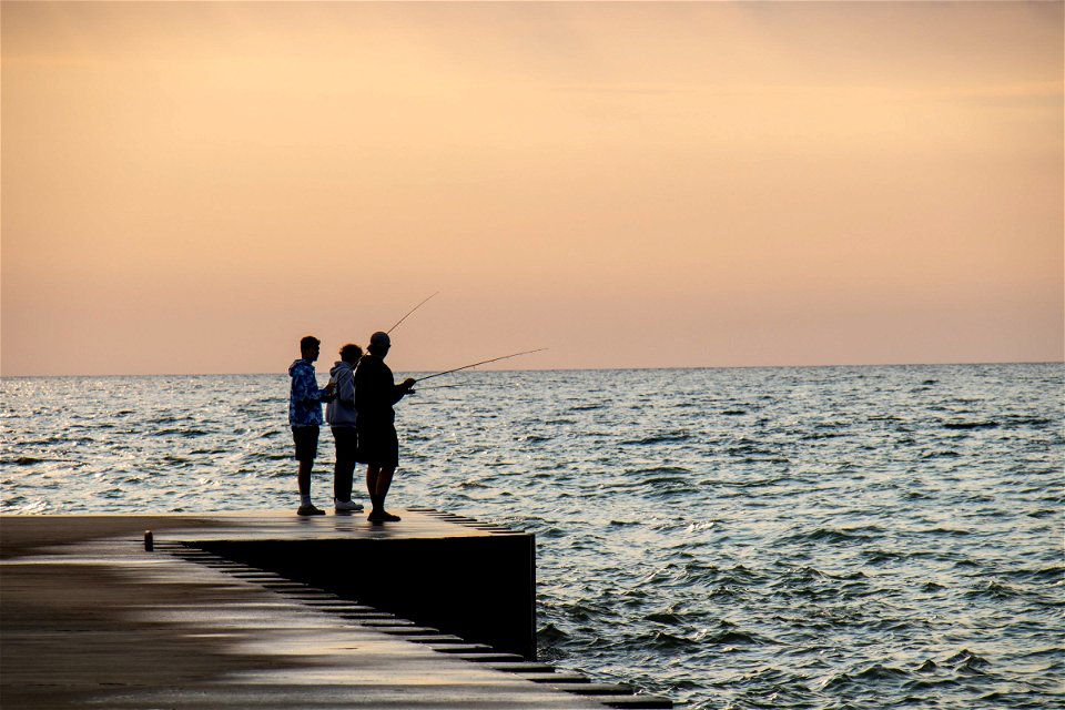 Three Men Fishing On Dock photo