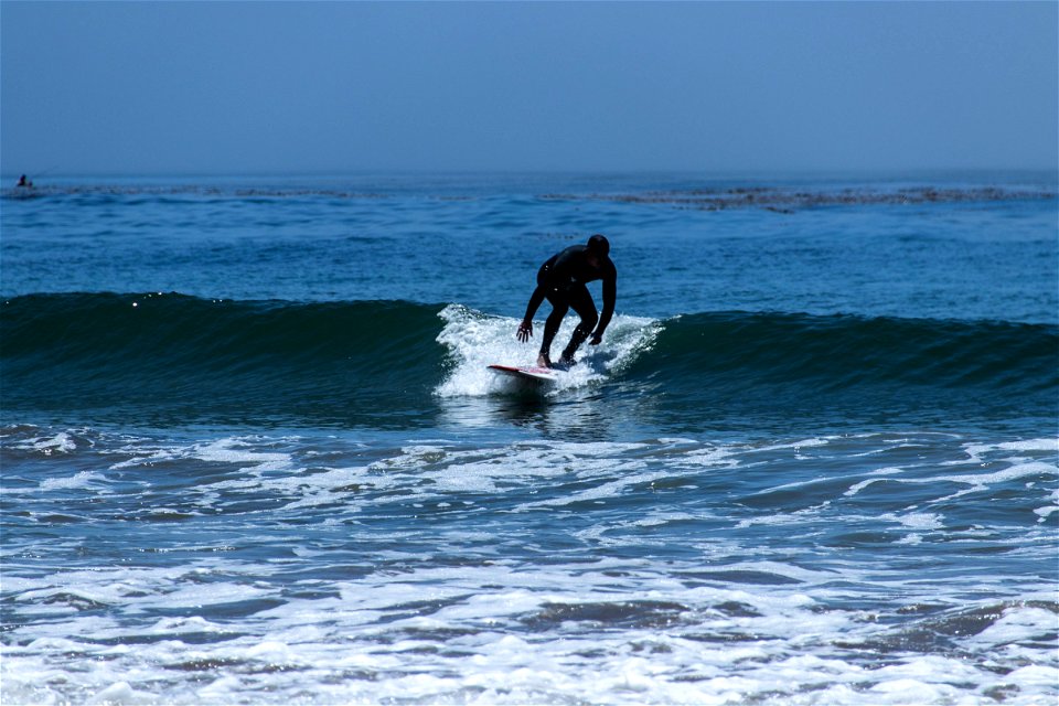 Man In Black Wetsuit Surfing Small Waves photo