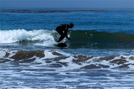 Man Riding Waves On Surfboard photo