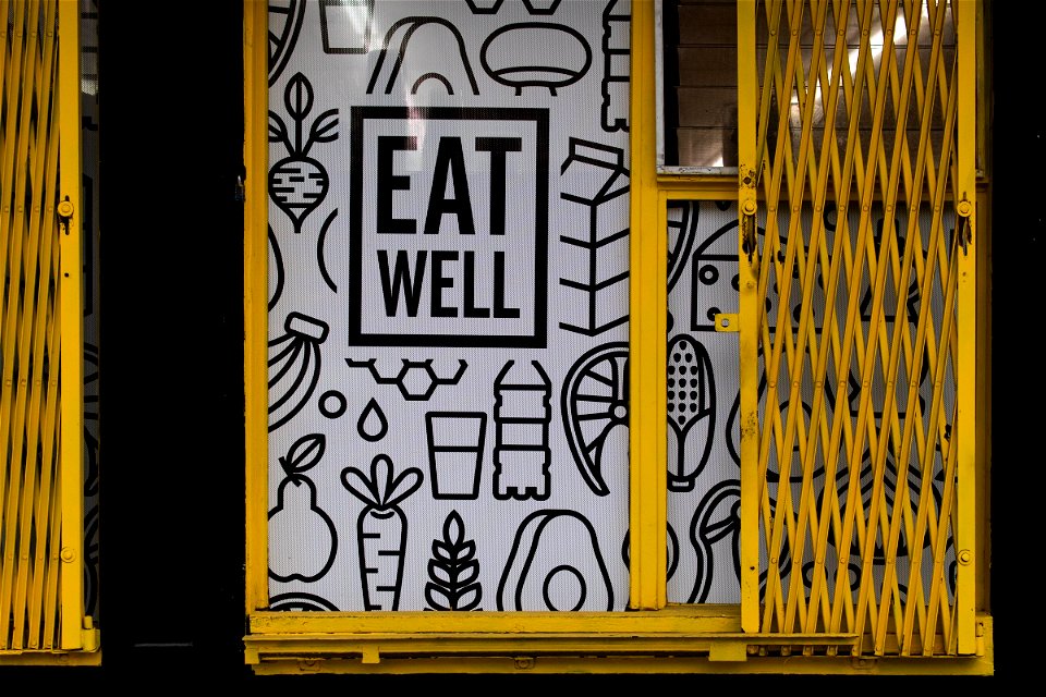 Eat Well Illustration On Storefront With Folding Doors photo