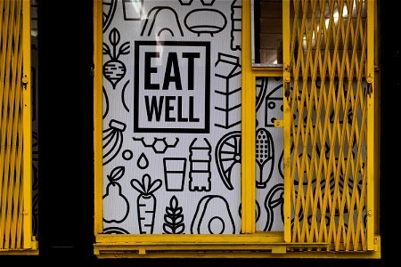 Eat Well Illustration On Storefront With Folding Doors photo