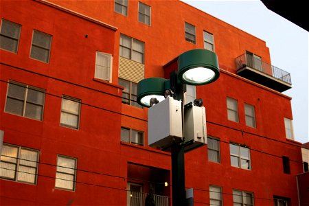 Streetlight In Front Of Red Orange Apartment Building photo
