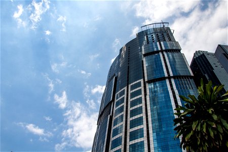 Tall Glass Building Against Sky photo