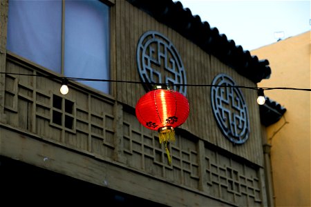 Red Paper Lantern On String Against Building
