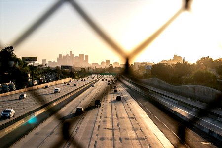 Light Traffic In Divided Highway Through Wire Mesh photo