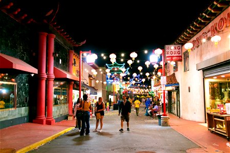 People In Brightly Lit Street In Chinatown At Night photo