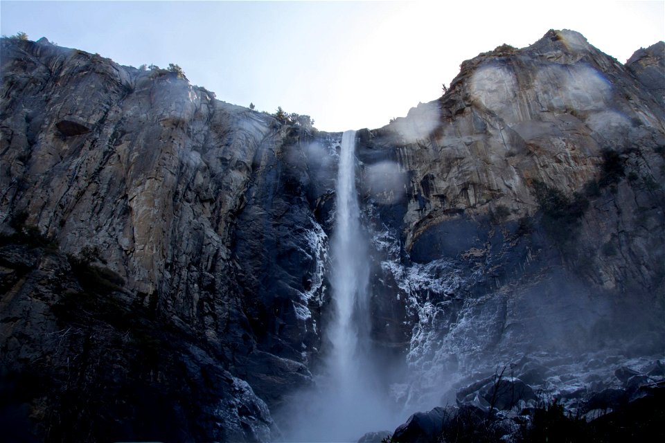 Narrow Waterfall On High Mountain Cliff photo