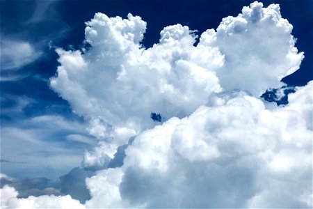 Soft Looking Puffy White Clouds In Blue Sky photo