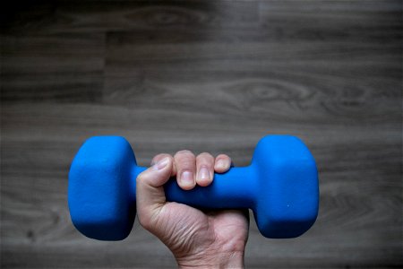Left Hand Holding Blue Dumbbell