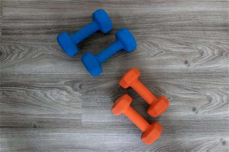 Two Sets Of Dumbbells On Wood