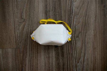 Face Mask With Yellow Bands On Wood photo