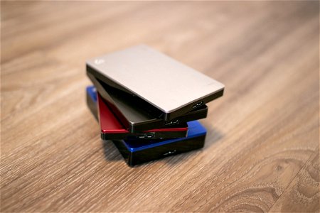 Stack Of Four Hard Disks On Wood photo