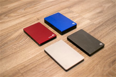 Four External Hard Disks On Wood photo