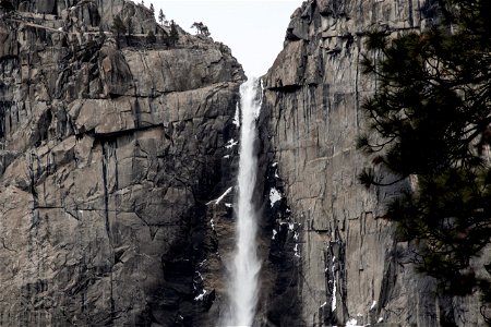 Waterfall On Jagged Rock Cliff