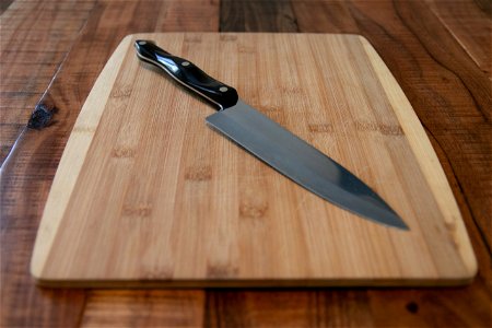 Chef’s Knife On Wood Cutting Board photo