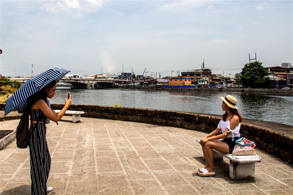 Two Women Taking Pictures Near River