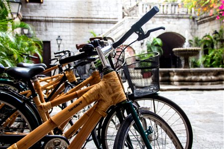 Bamboo Bicycles Parked Near Water Fountain photo