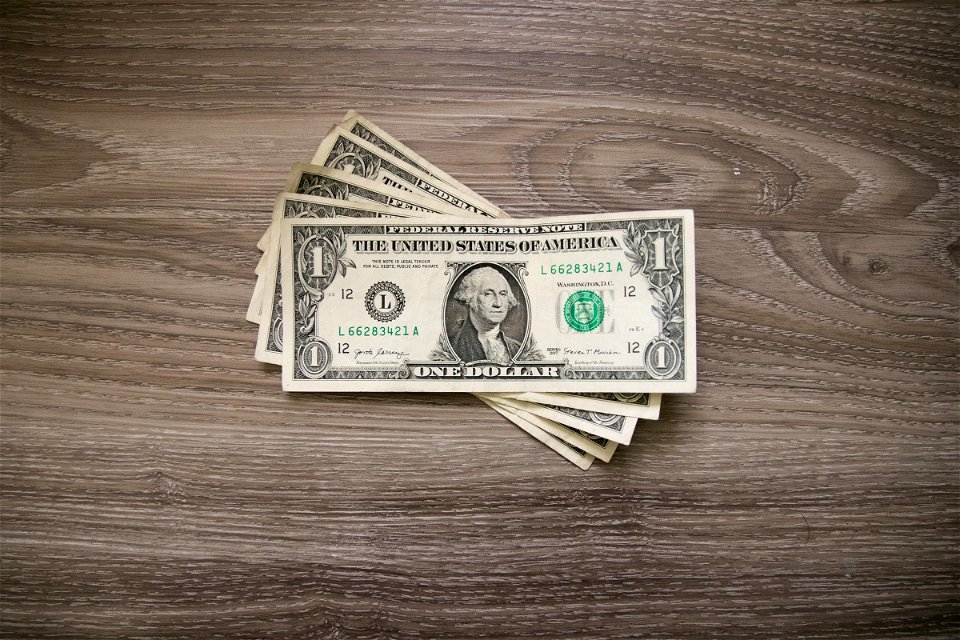 One Dollar Bills On Wood