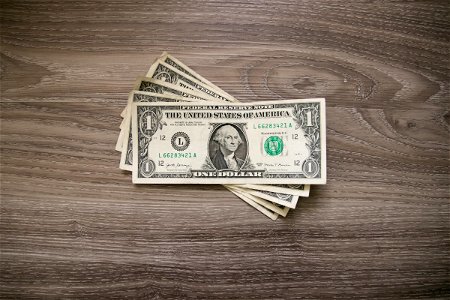 One Dollar Bills On Wood