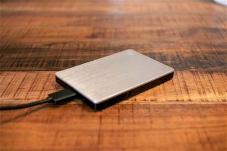 Plugged External Hard Disk On Wood photo