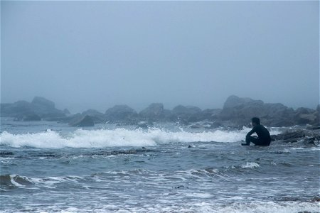 Person Sitting Near Waves photo