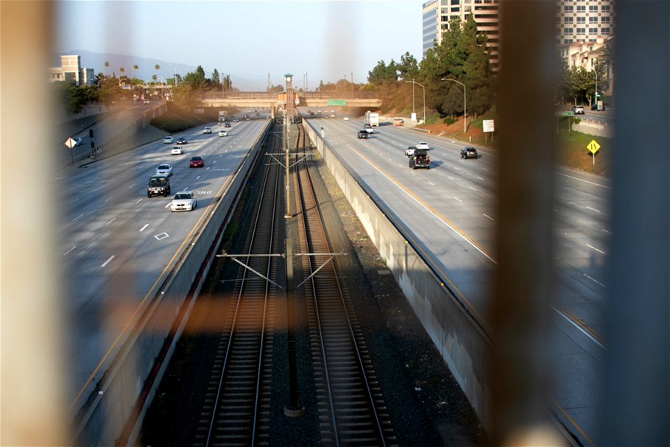 Traffic In Highway Through Wire Fence photo