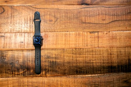 Black Smart Watch On Wooden Surface photo