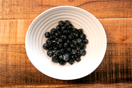 White Bowl Of Blueberries On Wooden Surface