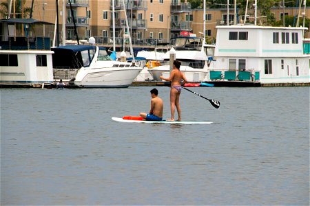 Two People On Surfboard On Water photo