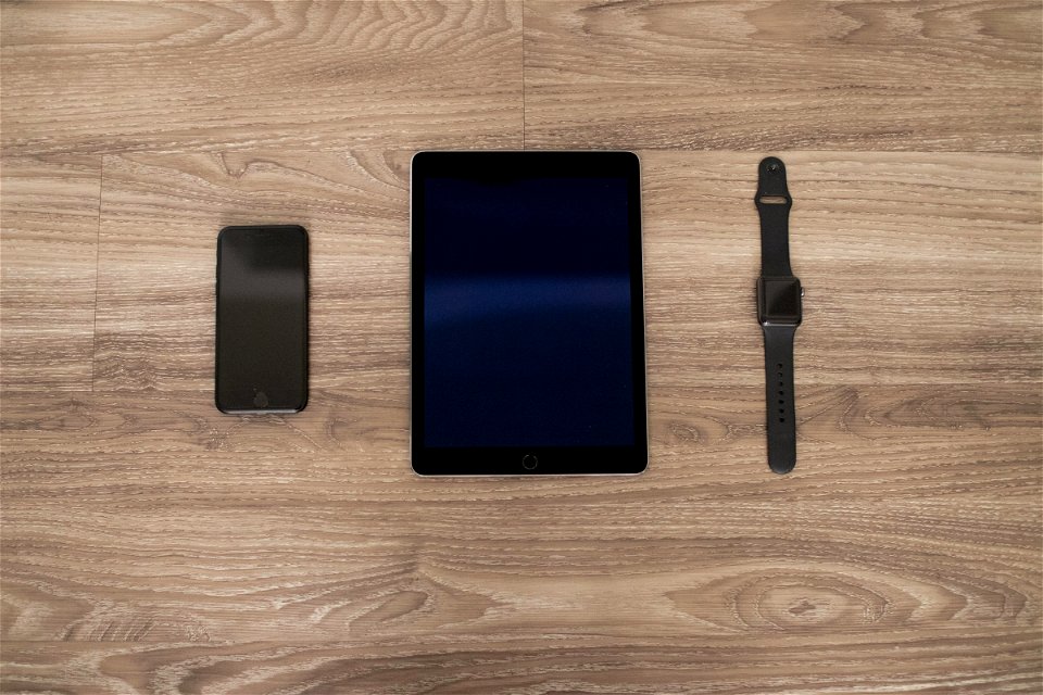 Apple Devices On Wooden Surface