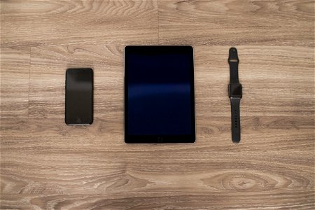 Apple Devices On Wooden Surface photo