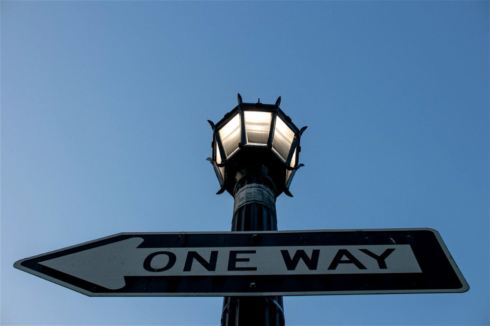 One Way Sign On Street Light Pole