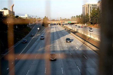 Light Traffic In Highway Visible Through Wire Fence photo