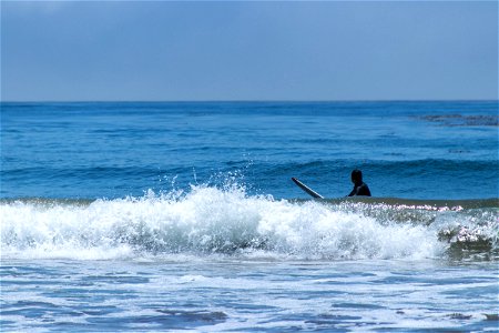Surfer In Water Visible Behind Waves photo
