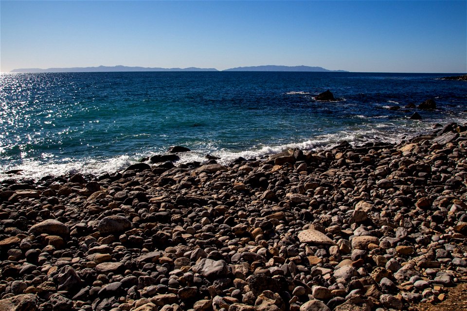 Water Twinkling Near Boulder Beach Shore photo