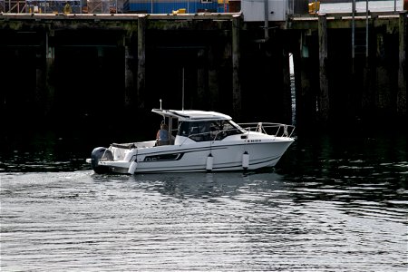 White Motorboat On Water Near Pier photo