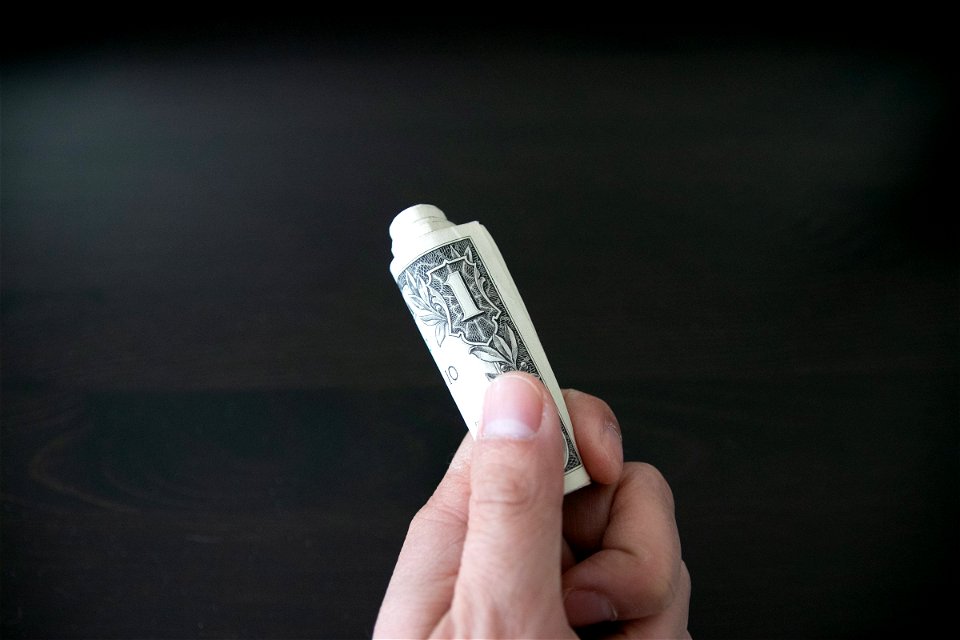 Hand Holding Rolled Us Dollar Bills