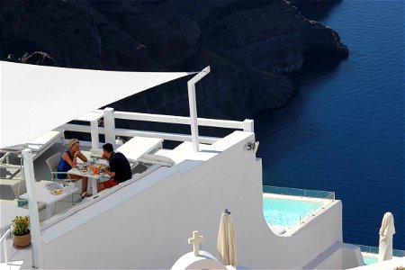 Two People In Restaurant Terrace Overlooking Water