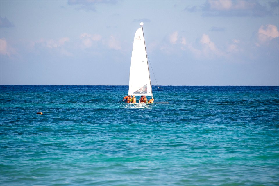 People On Longboard Windsurfer On Water photo